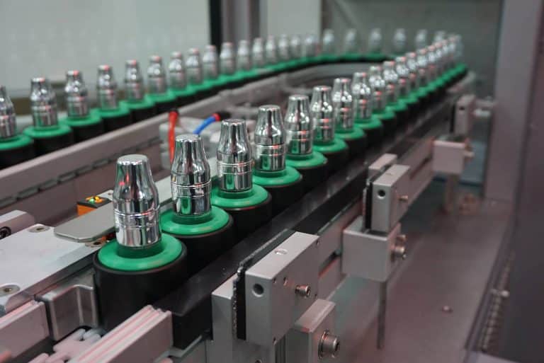 a packaging line with caps or bottles being screwed on